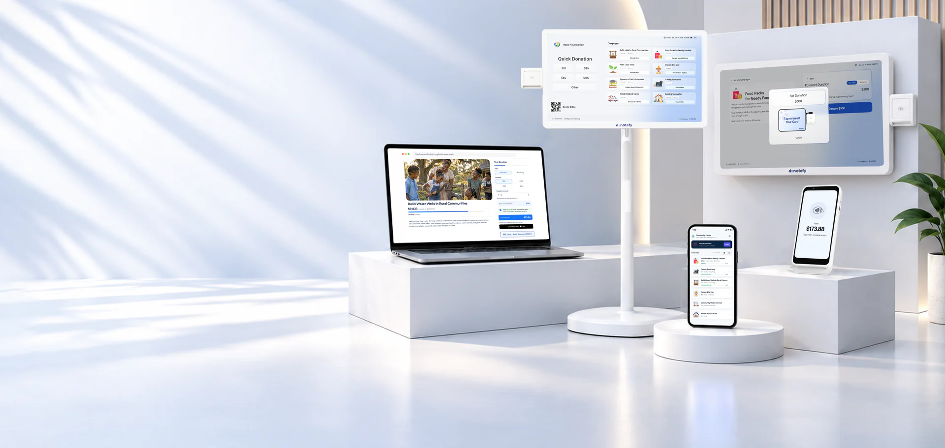 Donatefy devices together: a floor-standing kiosk, a wall-mounted kiosk, a laptop showing a campaign page, and phones running the app